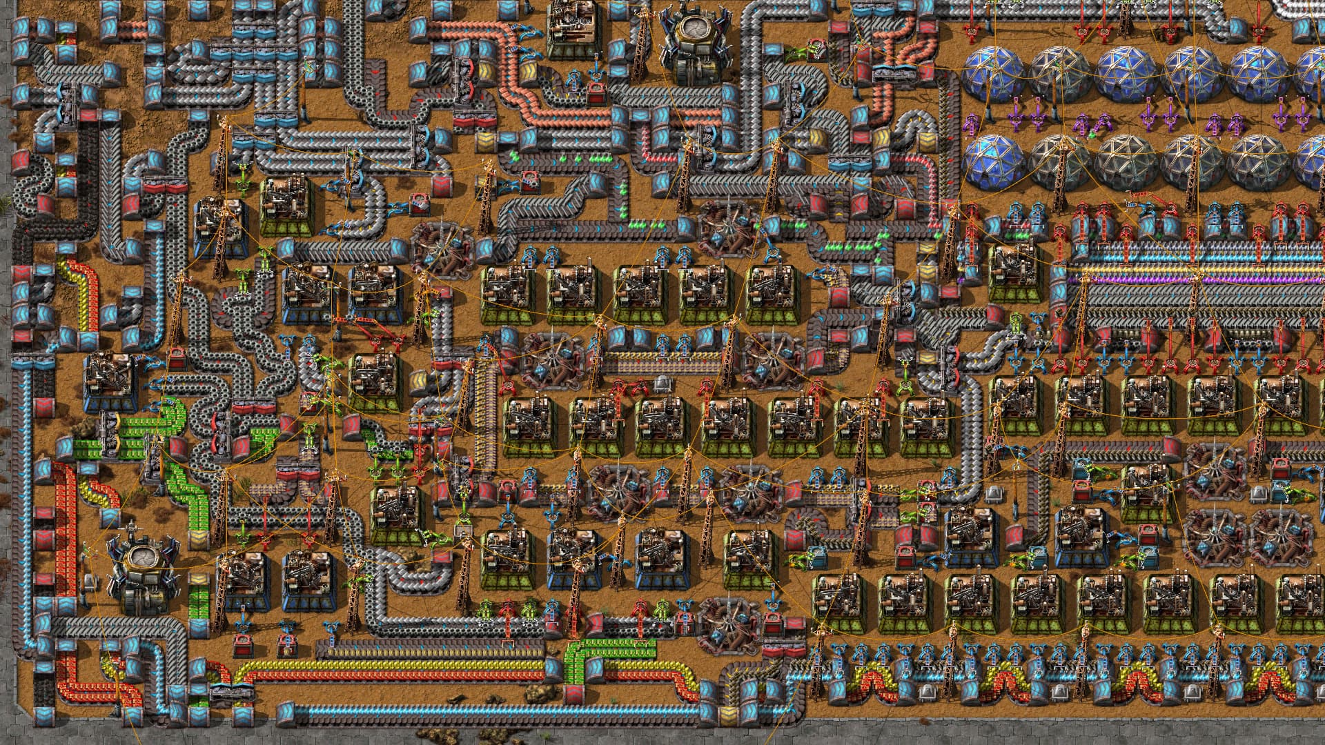 Montagemaschinen, Greifarme und dicht geführte Förderbänder in Factorio neben Forschungslaboren.