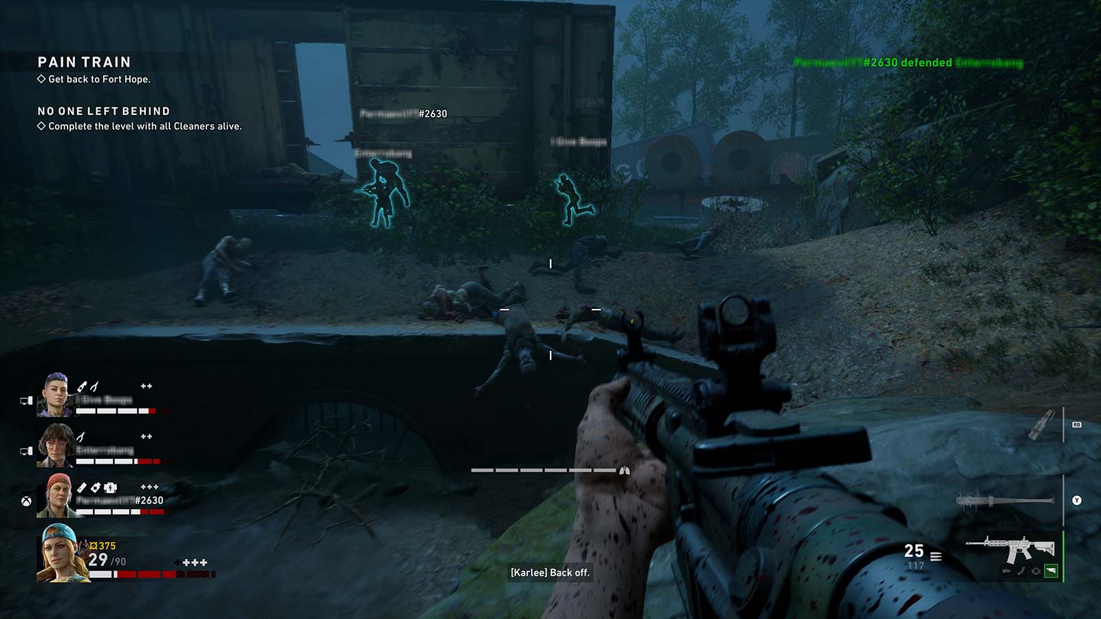 Back 4 Blood: First-person rifle combat beside railway cars, with teammate outlines, health and ammunition visible.